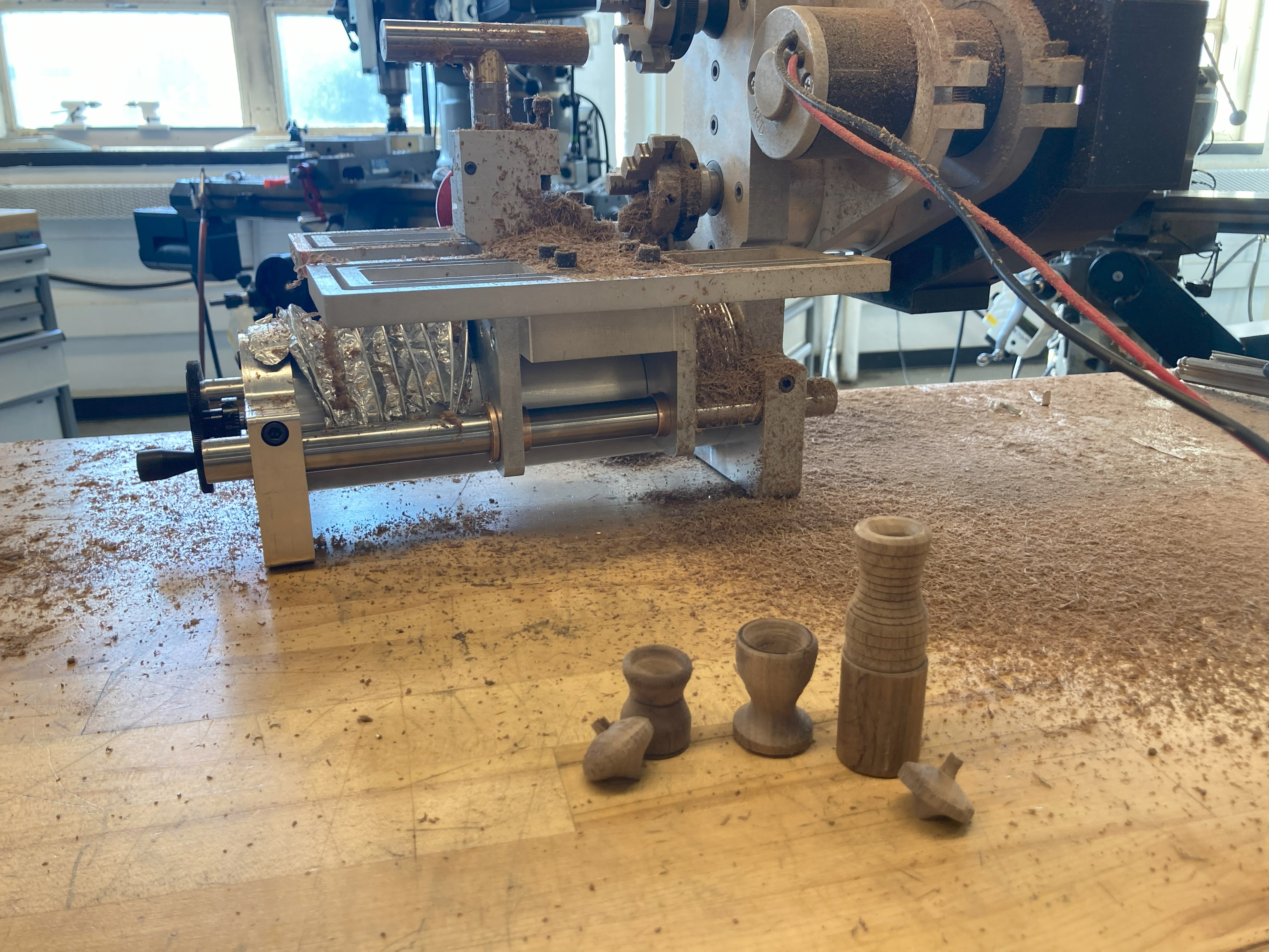 Wood pieces made on the lathe with the lathe in the background